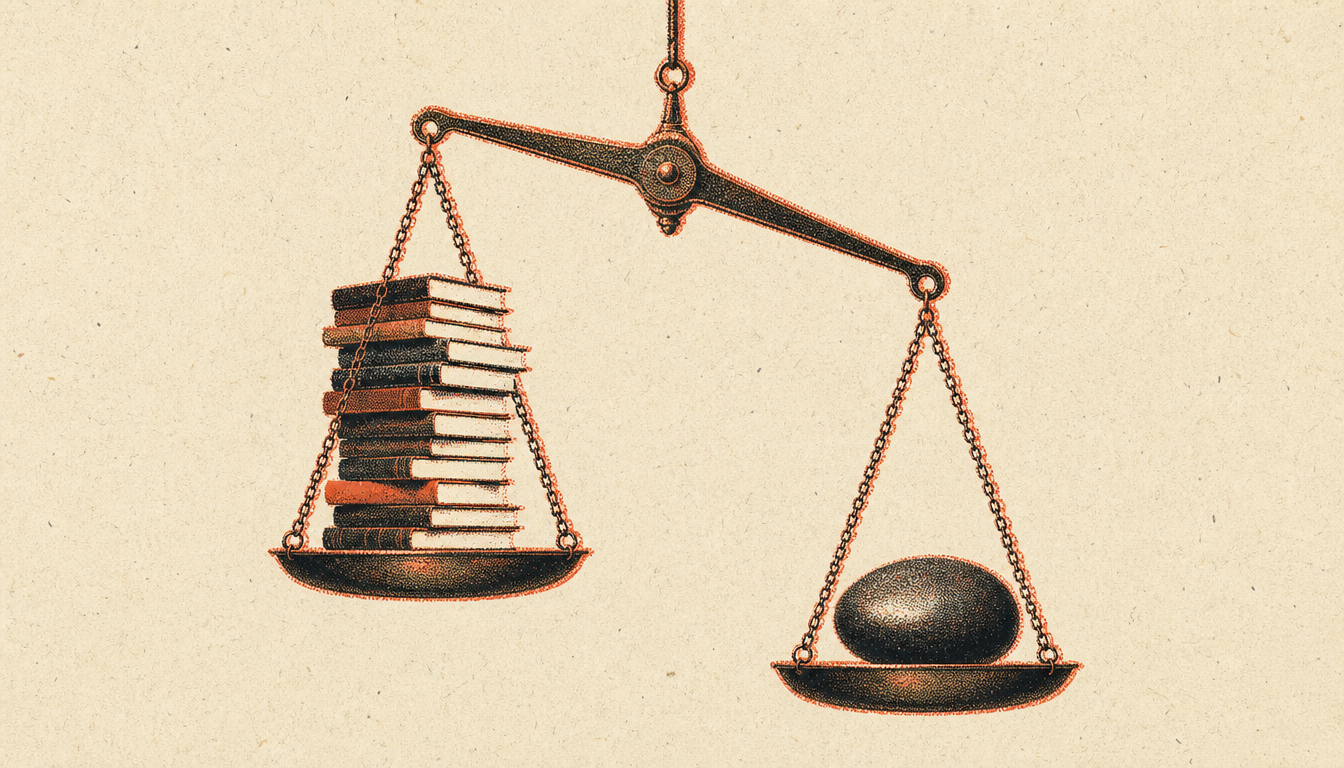 Brass scale weighing books against a stone to measure the knowledge action gap